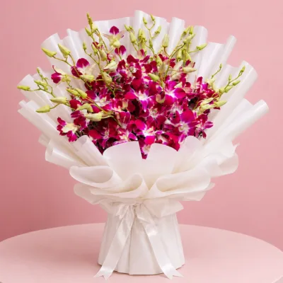 15 royal purple orchids with green accents wrapped in a white sheet.