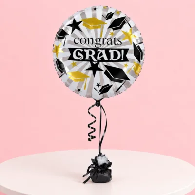 Round foil balloon featuring a Congrats Grad graduation theme