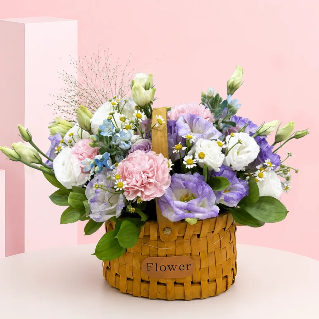 Fresh lisianthus and carnation with seasonal fillers and lush greenery, designed as a premium basket arrangement.