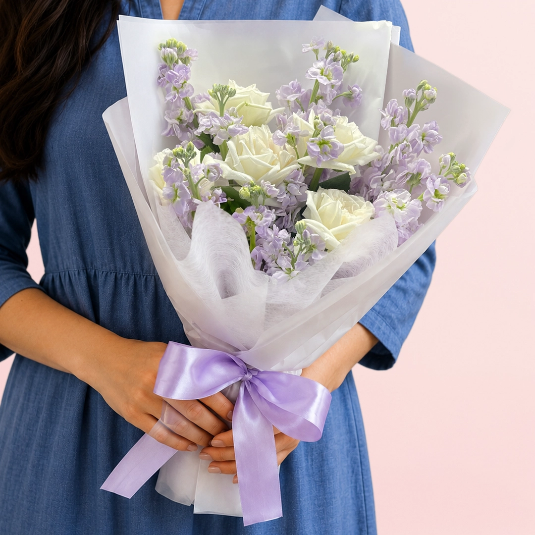 rose-and-matthiola-collection Fresh white roses paired with fragrant matthiola, beautifully wrapped in a white sheet with lush greenery and delicate fillers.